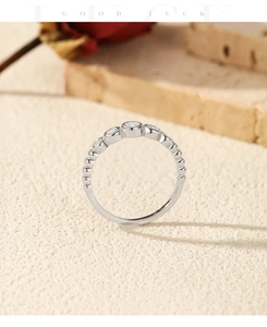 Detail of S925 silver ring with five round diamonds and vintage beaded texture