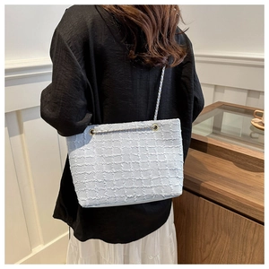 Model view of the light blue tweed tote bag showing its back side for daily commute style