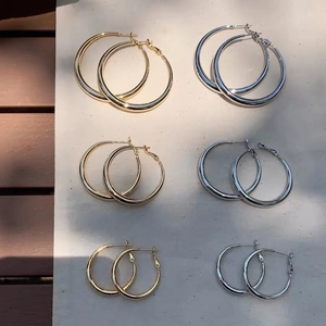 Classic thick hoop earrings in gold and silver finishes across three various sizes