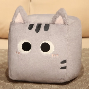 Detail of square gray plush cat pillow showing soft fabric texture and cute cartoon ears
