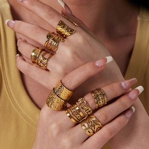 Close-up of bohemian 18K gold plated stainless steel rings stacked on a model's hand