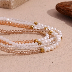 Detailed view of freshwater pearls and amber faceted crystals with gold spacer beads