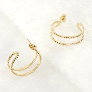 Chic 18K gold plated stainless steel hoop earrings with beaded texture on white plush