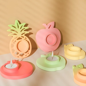 Creative fruit-shaped candle holders in pineapple and apple designs for home decor