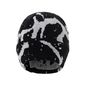 Winter knit beanie with black and white cow pattern and warm fleece lining