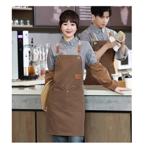 Brown canvas waterproof apron and sleeve set shown in a professional cafe setting