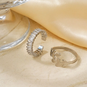 Adjustable silver rings set with rectangular cubic zirconia and hollow leaf designs