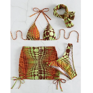 Flat lay of 4-piece swimwear set featuring retro geometric polka dot print and halter top