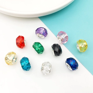 Close-up of colorful faceted 13mm resin beads with metal core for DIY jewelry making