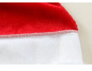 Close-up of high-quality red plush fabric and white trim with detailed stitching on Santa hat