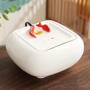 Minimalist white ceramic pet water fountain with red fish and gold ingot ornaments