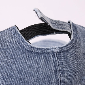 Detail of adjustable velcro strap on light blue denim baseball cap for kids