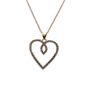 Detailed macro view of a golden double-layered hollow heart pendant with clear zircons