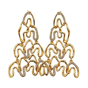 Golden irregular geometric wave earrings with sparkling zircon crystals in a lava style