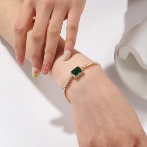 Elegant gold bracelet with emerald rectangle stones and pavé cubic zirconia for women