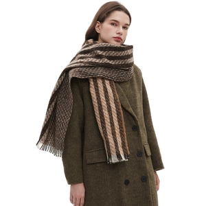 Brown striped wool winter scarf with tassels shown on a model against white background