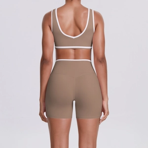 Detail of cross waist yoga set showing brown contrast trim and high elasticity fabric texture