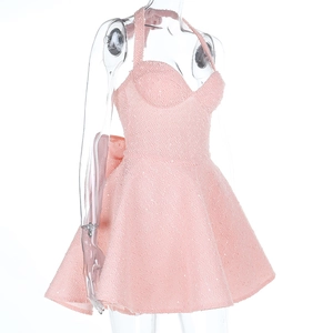 Detailed view of the oversized pink bow and sparkling sequin texture on the back of dress