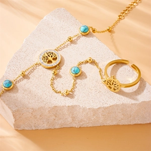 Golden Tree of Life turquoise bracelet ring chain with rhinestones on stone background