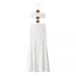 Elegant white halter neck maxi dress with gold metal rings and fluid silhouette