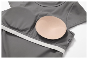 Detail of grey yoga top showing removable XS breast pads and flatlock stitching
