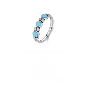 Macro detail of S925 sterling silver ring with blue turquoise and white cubic zirconia