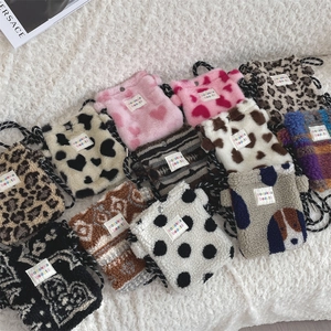 Variety of plush mini crossbody bags with animal prints and patterns on a soft rug