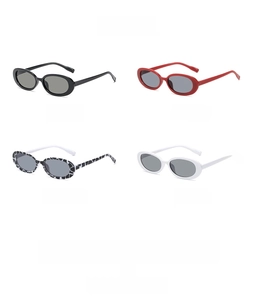 Detail view of four retro small oval sunglasses in black, red, floral, and white frames