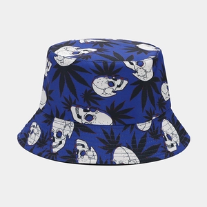Detail of royal blue reversible bucket hat with white skull and leaf print
