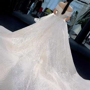 Luxurious off-shoulder starry bridal gown with sparkling sequins and long royal train
