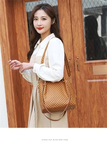 Detail of vintage brown monogram tote bag with sturdy handles and adjustable strap