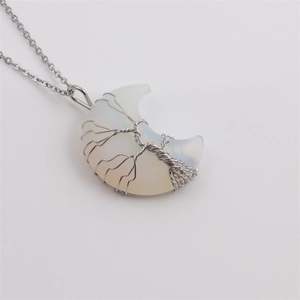 Detail of tree of life silver wire wrapped opalite moon pendant necklace