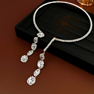 Macro view of silver Y-shaped necklace with sparkling rhinestone tassels on tray