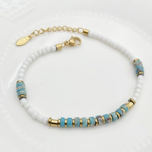 Detail of beaded bracelet with blue marble stones and gold stainless steel spacers