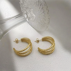 Elegant gold-plated geometric C-shaped earrings with a triple-layered braided texture