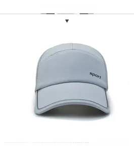 Detail of grey sports cap with breathable mesh fabric and reflective brim stripes