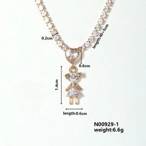 Detailed macro view showing a gold heart and girl pendant with size measurements