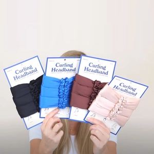 Set of four foam heatless hair curlers in black, blue, burgundy and pink for flawless curls