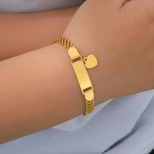 Detail of baby gold woven mesh bracelet with blank engravable ID tag and heart charm
