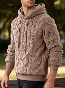 Detailed texture of brown cable knit fleece hoodie featuring warm hooded drawstring design