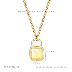Close-up of 18K gold lock pendant necklace with letter Y engraving and exact dimensions