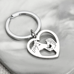 Polished silver heart stainless steel keychain with girl and horse silhouette