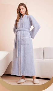 Detail of soft fleece bathrobe with white piping trim and large front pockets
