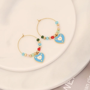 Colorful beaded heart earrings with gold hoops and blue enamel heart pendants