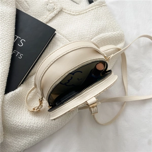 Straw flower round crossbody bag with PU leather details and spacious interior view