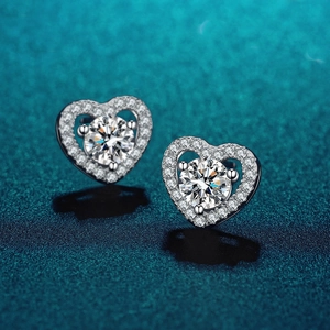 Macro shot of 925 sterling silver heart-shaped moissanite stud earrings with a shiny reflection