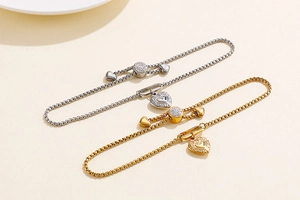 Close-up of adjustable heart sliders and square box chain in gold and silver finishes