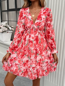 Close-up of V-neckline and pink floral print on long sleeve elegant mini dress