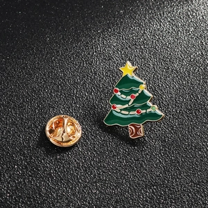 Cute green enamel Christmas tree brooch with colorful dots and a gold butterfly clutch