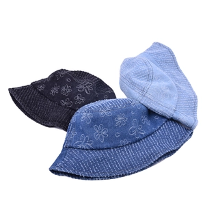 Denim bucket hats with white floral patterns and frayed edges in three shades